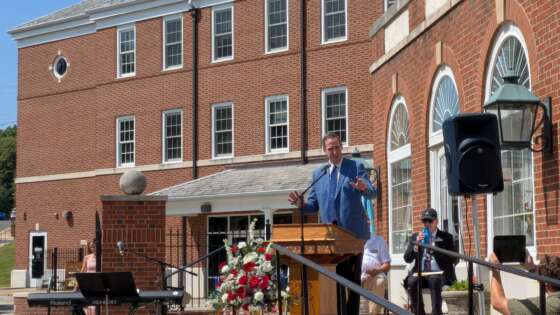 Pastor Dan speaking to crowd at July 5 service